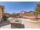 Private backyard pool with a charming rock waterfall feature, patio, desert landscaping, and privacy fence at 17244 W Mohave St, Goodyear, AZ 85338