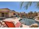 Beautiful private backyard pool with rock features, desert landscaping, outdoor seating, and privacy at 17244 W Mohave St, Goodyear, AZ 85338
