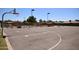 A well-maintained basketball court with painted lines, hoops, and lighting for enjoyable outdoor recreation at 1905 E Inverness Ave, Mesa, AZ 85204