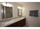 Stylish bathroom featuring double sinks with granite countertops and framed mirrors at 1905 E Inverness Ave, Mesa, AZ 85204