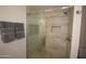 Modern bathroom with glass enclosed shower and tiled walls, with a towel nook at 1905 E Inverness Ave, Mesa, AZ 85204