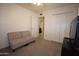 Bright bedroom with neutral carpet, loveseat, and a closet for ample storage space at 1905 E Inverness Ave, Mesa, AZ 85204