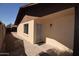 Side exterior of home with a brick-lined walkway and a secure, screened entrance at 1905 E Inverness Ave, Mesa, AZ 85204
