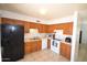 Functional kitchen with wooden cabinets, white appliances and a neutral color palette at 1905 E Inverness Ave, Mesa, AZ 85204
