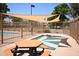 Relaxing community pool and spa area shaded by sun sails, with a picnic table nearby at 1905 E Inverness Ave, Mesa, AZ 85204