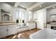 Bright bathroom boasts a window seat, dual vanities, and wood flooring at 19922 N 101St Pl, Scottsdale, AZ 85255