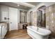Elegant bathroom with freestanding tub, walk-in shower, and vanity area at 19922 N 101St Pl, Scottsdale, AZ 85255