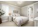 Cozy bedroom featuring plush bedding, plantation shutters, and ample natural light at 19922 N 101St Pl, Scottsdale, AZ 85255