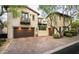 Charming home featuring a brick driveway, two-car garage, and an upper-level balcony at 19922 N 101St Pl, Scottsdale, AZ 85255