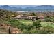 Expansive property overlooking a pristine golf course with stunning mountain views in the distance at 19922 N 101St Pl, Scottsdale, AZ 85255