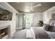 Light-filled main bedroom featuring a fireplace, balcony access, and a tranquil atmosphere for ultimate relaxation at 19922 N 101St Pl, Scottsdale, AZ 85255