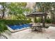 Inviting pool area with water features, an umbrella-covered dining set, and lush landscaping at 19922 N 101St Pl, Scottsdale, AZ 85255