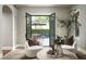Sitting room with French doors opening to an outdoor patio and pool, offering a seamless indoor-outdoor living experience at 19922 N 101St Pl, Scottsdale, AZ 85255