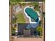 Aerial view of a backyard pool, pergola, and green space with desert landscaping at 20426 N Alma Dr, Maricopa, AZ 85138