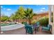 Inviting patio with dining set overlooking a private pool and lush desert landscaping at 20426 N Alma Dr, Maricopa, AZ 85138