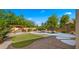 Spacious backyard featuring pool, lush landscaping, a rock waterfall and a charming pergola with seating at 20426 N Alma Dr, Maricopa, AZ 85138