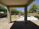 Framed view of the backyard featuring a sparkling pool, lush landscaping, and a cozy pergola at 20426 N Alma Dr, Maricopa, AZ 85138