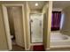 Well-lit bathroom with glass enclosed shower, tub, and tiled floor at 20426 N Alma Dr, Maricopa, AZ 85138