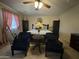 Well-lit bedroom with sitting area, ceiling fan, and coordinating bedding at 20426 N Alma Dr, Maricopa, AZ 85138