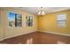 Bright bedroom features hardwood floors, ceiling fan, and large windows that provide great natural light at 20426 N Alma Dr, Maricopa, AZ 85138