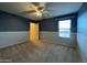 Bedroom featuring carpet, two-tone walls and a ceiling fan at 20426 N Alma Dr, Maricopa, AZ 85138