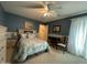 Inviting bedroom with a ceiling fan and natural light, perfect for relaxation and rest at 20426 N Alma Dr, Maricopa, AZ 85138