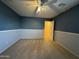 Bedroom featuring carpet, two-tone walls, ceiling fan and attached closet at 20426 N Alma Dr, Maricopa, AZ 85138