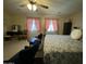 Spacious bedroom with sitting area, ceiling fan, and coordinating bedding at 20426 N Alma Dr, Maricopa, AZ 85138