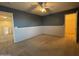 Spacious bedroom with two-tone walls and open doorway at 20426 N Alma Dr, Maricopa, AZ 85138
