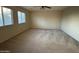 Large bedroom features carpet, ceiling fan and two windows at 20426 N Alma Dr, Maricopa, AZ 85138
