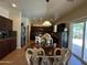 Dining area with views of the kitchen and access to the backyard through sliding glass doors at 20426 N Alma Dr, Maricopa, AZ 85138