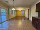 Bright dining room with an open layout, tile floors, sliding glass doors, and large windows for ample natural light at 20426 N Alma Dr, Maricopa, AZ 85138