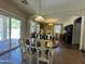 Bright dining area with sliding glass doors and views into the living room at 20426 N Alma Dr, Maricopa, AZ 85138