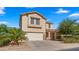 Charming two-story home featuring a well-manicured lawn, desert landscaping, and a two-car garage at 20426 N Alma Dr, Maricopa, AZ 85138