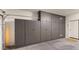 Garage featuring custom cabinets for organized storage, enhancing functionality and aesthetics at 20426 N Alma Dr, Maricopa, AZ 85138
