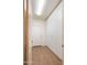 Hallway with ample built-in storage cabinets and tile flooring, blending practicality and style at 20426 N Alma Dr, Maricopa, AZ 85138