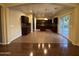 Open-concept kitchen with stainless steel appliances and an island, seamlessly connected to the dining and living areas at 20426 N Alma Dr, Maricopa, AZ 85138