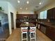 Modern kitchen with stainless steel appliances, granite countertops, and ample cabinet space at 20426 N Alma Dr, Maricopa, AZ 85138