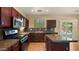 Modern kitchen boasts granite countertops, stainless steel appliances, and an island with bar seating at 20426 N Alma Dr, Maricopa, AZ 85138