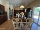 Dining area with views of the kitchen and access to the backyard through sliding glass doors at 20426 N Alma Dr, Maricopa, AZ 85138