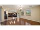 Open-concept living area with hardwood floors, ample natural light, and seamless flow into the kitchen at 20426 N Alma Dr, Maricopa, AZ 85138