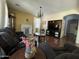 Spacious living room with hardwood floors, decorative fireplace, and comfortable seating arrangements at 20426 N Alma Dr, Maricopa, AZ 85138
