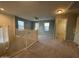 Open loft area with natural light from several windows, staircase access, and neutral carpet for a modern and versatile space at 20426 N Alma Dr, Maricopa, AZ 85138