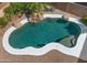 Aerial view of a backyard pool with rock waterfall and palm trees at 20426 N Alma Dr, Maricopa, AZ 85138