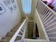 Carpeted staircase with white railing ascending to the second floor of the home at 20426 N Alma Dr, Maricopa, AZ 85138