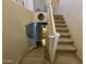 Carpeted staircase with white railing looking down from the second floor of the home at 20426 N Alma Dr, Maricopa, AZ 85138