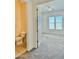 View of the bedroom from the ensuite bathroom with carpet and neutral walls at 20472 W Daniel Pl, Buckeye, AZ 85396