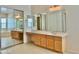 Large bathroom vanity with framed mirrors and sliding closet doors at 20472 W Daniel Pl, Buckeye, AZ 85396