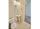 The bathroom features a pedestal sink, toilet, and a framed mirror at 20472 W Daniel Pl, Buckeye, AZ 85396
