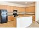 Spacious kitchen with light wood cabinets, granite countertops, and stainless steel appliances at 20472 W Daniel Pl, Buckeye, AZ 85396